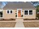 Charming home exterior with orange front door, covered porch, and manicured garden at 518 W Chisholm St, Sanford, NC 27330