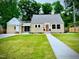 Charming single-Gathering home with a well-maintained front yard and inviting, bright colored front door at 518 W Chisholm St, Sanford, NC 27330