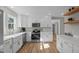 Modern kitchen featuring white cabinets, stainless steel appliances, and hardwood floors at 518 W Chisholm St, Sanford, NC 27330
