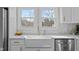 Bright kitchen with view from double windows above a farmhouse sink with stainless steel appliances at 518 W Chisholm St, Sanford, NC 27330