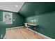 Cozy office space featuring wood floors, desk, chair, and an accent wall at 518 W Chisholm St, Sanford, NC 27330