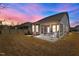 Backyard with a screened porch, patio and grill under a sunset sky that enhances outdoor living at 5212 Huntley Overlook Dr, Durham, NC 27703