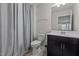 Well-lit bathroom featuring a modern vanity, toilet, and shower with elegant curtain, providing a comfortable experience at 5212 Huntley Overlook Dr, Durham, NC 27703