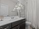 Bathroom featuring a white vanity, decorative mirror, and shower with white curtain at 5212 Huntley Overlook Dr, Durham, NC 27703
