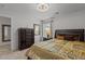Cozy bedroom with plush bedding, ample storage, and a sun-filled window, creating a relaxing atmosphere at 5212 Huntley Overlook Dr, Durham, NC 27703