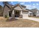 Charming home with stone accents, a welcoming porch, and a well-manicured lawn, radiating curb appeal at 5212 Huntley Overlook Dr, Durham, NC 27703