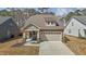 Charming single-Gathering home boasts a spacious driveway and attached two-car garage at 5212 Huntley Overlook Dr, Durham, NC 27703