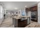 Bright, modern kitchen with stainless steel appliances, center island, and open-concept living area at 5212 Huntley Overlook Dr, Durham, NC 27703