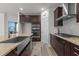 Modern kitchen boasts stainless steel appliances, granite countertops, and dark wood cabinetry at 5212 Huntley Overlook Dr, Durham, NC 27703