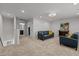 Spacious living room featuring plush carpeting, modern lighting, comfortable seating, and an elegant decor at 5212 Huntley Overlook Dr, Durham, NC 27703