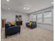 Inviting living room with plush carpeting, modern lighting, comfortable seating, and sun-filled windows at 5212 Huntley Overlook Dr, Durham, NC 27703