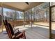 Relaxing screened porch with wood flooring, comfortable seating, and serene views of the outdoor landscape at 5212 Huntley Overlook Dr, Durham, NC 27703