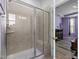 Modern bathroom featuring a tiled shower with glass doors, bench, and built-in shelf, adding a touch of elegance at 5212 Huntley Overlook Dr, Durham, NC 27703