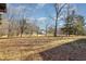 Expansive backyard with mature trees, offering privacy and a serene view of the property at 5315 Cole Mill Rd, Durham, NC 27705