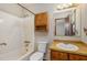Cozy bathroom with a tub/shower combo, vanity, and mirrored cabinet for storage at 5315 Cole Mill Rd, Durham, NC 27705
