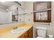 This bathroom features a vanity with a sink, a large mirror, and a window providing natural light at 5315 Cole Mill Rd, Durham, NC 27705