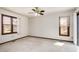 Bright bedroom featuring plush carpet, a ceiling fan, and natural light from two windows at 5315 Cole Mill Rd, Durham, NC 27705