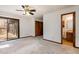 Comfortable main bedroom with a ceiling fan, closet, and sliding glass doors to the deck at 5315 Cole Mill Rd, Durham, NC 27705