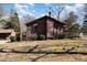 A charming home with brown siding, surrounded by mature trees, and featuring a wooden deck at 5315 Cole Mill Rd, Durham, NC 27705