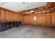 Spacious garage with natural wood walls and ceiling, concrete floor, built-in storage, and window for natural light at 5315 Cole Mill Rd, Durham, NC 27705