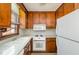Functional kitchen featuring bright countertops, essential appliances, and wood cabinetry at 5315 Cole Mill Rd, Durham, NC 27705