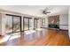 Bright living room with hardwood floors, a stone fireplace, and glass doors to the deck at 5315 Cole Mill Rd, Durham, NC 27705
