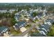 Aerial view of community with mature trees and water feature, showcasing the home's desirable location at 58 Lake Village Drive Dr, Durham, NC 27713