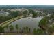 Aerial view of a beautiful lake, lush trees, and sidewalks at 58 Lake Village Drive Dr, Durham, NC 27713