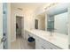 Bright bathroom with double sinks, vanity, large mirror, and a stand up shower at 58 Lake Village Drive Dr, Durham, NC 27713