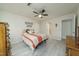Inviting bedroom with natural lighting, ceiling fan, and neutral paint at 58 Lake Village Drive Dr, Durham, NC 27713
