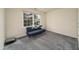 This bedroom offers ample natural light from the window and comfy blue futon at 58 Lake Village Drive Dr, Durham, NC 27713