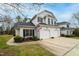 Charming white home with a two-car garage, black shutters, and a well-maintained front yard at 58 Lake Village Drive Dr, Durham, NC 27713