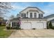 Charming white home with a two-car garage, black shutters, and a well-maintained front yard at 58 Lake Village Drive Dr, Durham, NC 27713