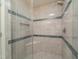 Stand up shower with neutral colored tile and blue accent tiling at 58 Lake Village Drive Dr, Durham, NC 27713