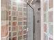 Modern tiled shower with glass doors and accessible grab bars for added safety at 6004 Bramblewood Dr, Raleigh, NC 27612