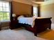 Bedroom featuring soft carpet, a dark wood bed frame, and natural light at 61 Langdon Pointe Dr, Garner, NC 27529