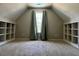 A spacious bedroom featuring neutral tones, a window and built in shelving units at 61 Langdon Pointe Dr, Garner, NC 27529