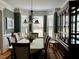 Charming dining room featuring wainscoting, a chandelier, and large windows for natural light at 61 Langdon Pointe Dr, Garner, NC 27529