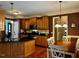 Well-equipped kitchen with wood cabinets, stainless steel appliances, and an adjacent dining area at 61 Langdon Pointe Dr, Garner, NC 27529