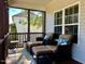 A screened patio with two cushioned chairs and a table, perfect for relaxing and outdoor enjoyment at 61 Langdon Pointe Dr, Garner, NC 27529