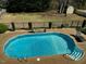 In-ground backyard pool with ladder in green grass at 61 Langdon Pointe Dr, Garner, NC 27529