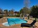 Backyard view of the pool with a nearby lounge chair at 61 Langdon Pointe Dr, Garner, NC 27529