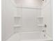 Bright bathtub and shower combination with built in shelving at 6434 Astor Elgin St, Raleigh, NC 27616