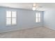 Light blue bedroom features carpet, white trim and two windows with shutters at 6434 Astor Elgin St, Raleigh, NC 27616