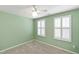 Bedroom with green walls, carpet, ceiling fan, and windows with shutters at 6434 Astor Elgin St, Raleigh, NC 27616