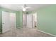 Bedroom with green walls, closet, and bathroom doors at 6434 Astor Elgin St, Raleigh, NC 27616