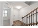 Welcoming entryway with hardwood floors, staircase with iron railings, and view into adjacent living space at 6434 Astor Elgin St, Raleigh, NC 27616