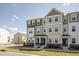 Desirable three-story townhomes with neutral color schemes and inviting entryways in a well-kept neighborhood at 6434 Astor Elgin St, Raleigh, NC 27616