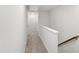 Upstairs hallway with carpet, white walls, and doors leading to other rooms at 6434 Astor Elgin St, Raleigh, NC 27616