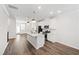 Modern kitchen with sleek island, stainless appliances, and hardwood floors at 6434 Astor Elgin St, Raleigh, NC 27616